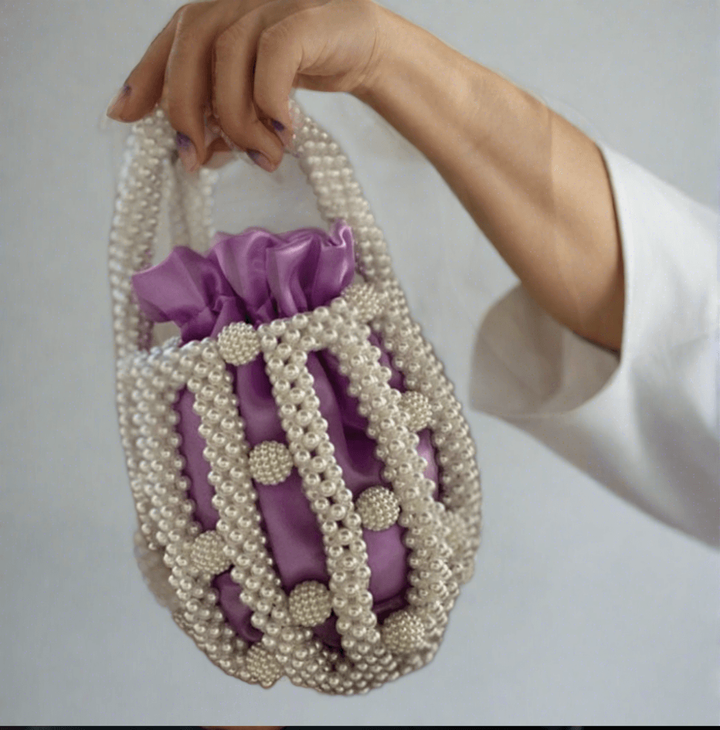 Pearl Purple Hue bucket bag -  Pearl bucket bag with detachable off white pouch inside Dimensions Height : 15 cm Shape: Cylinder Material : Faux High quality polished pearls with satin bag Pearl Purple Hue bucket bag Pearl bucket bag with detachable off white pouch inside Dimensions Height : 15 cm Shape: Cylinder Material : Faux High quality polished pearls with satin bag