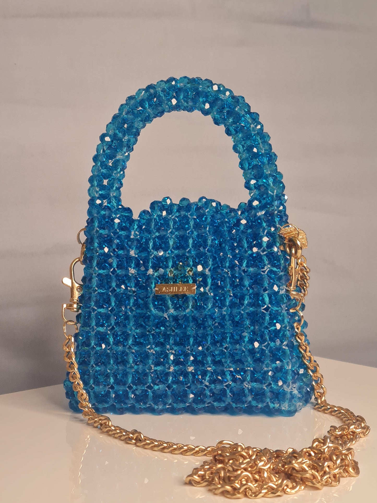 Nano Crystal Bag -  Nano crystal bag - Turquoise Blue Size : 12*10*8cm Crystal : Glass Sling : Yes Available on pre-order basis - 4 business days making time Nano Crystal Bag Nano crystal bag - Turquoise Blue Size : 12*10*8cm Crystal : Glass Sling : Yes Available on pre-order basis - 4 business days making time