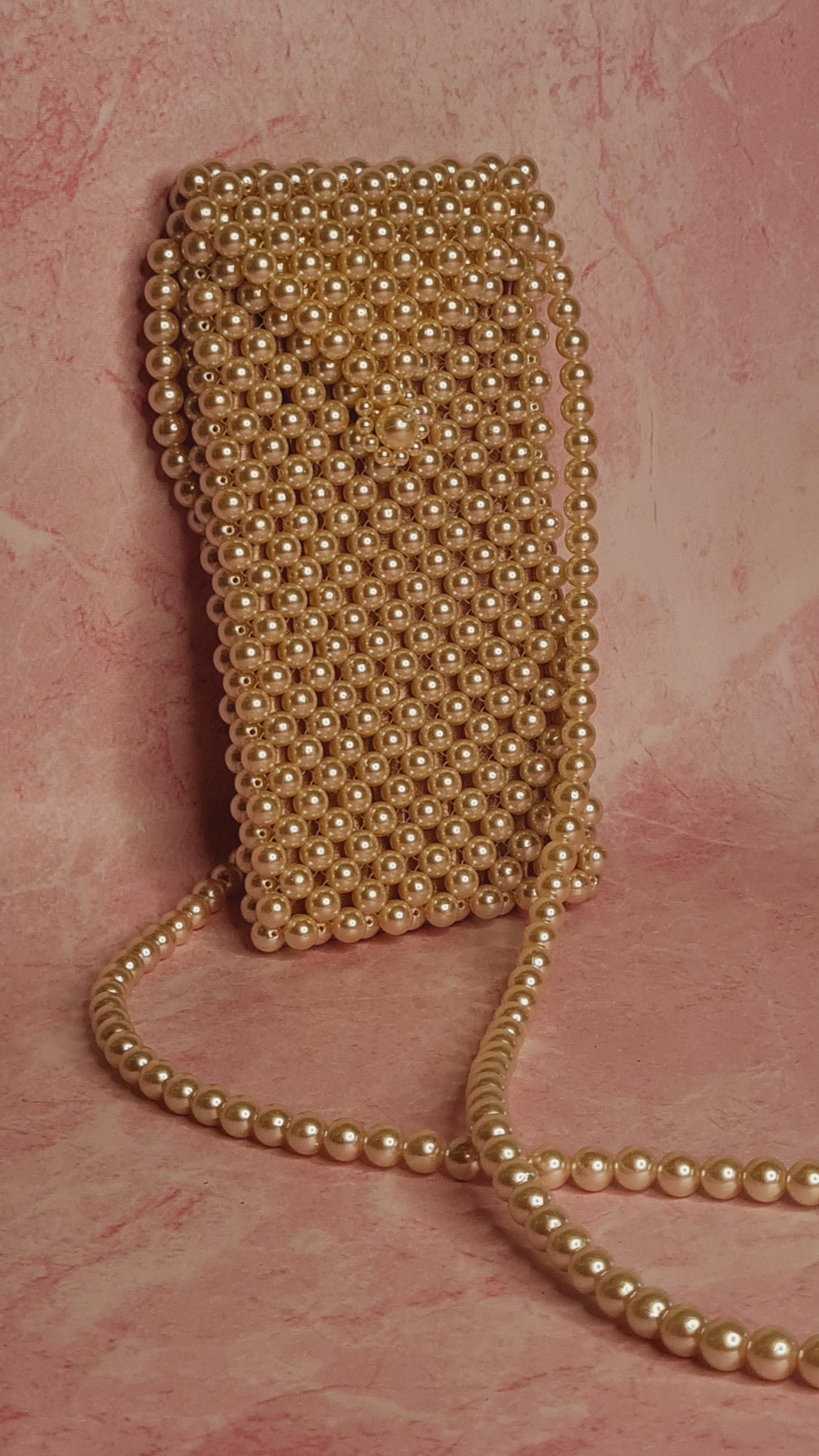 Pearl Phone Bag -  A pearl phone bag made with high end gloss finish faux pearls with warranty of shine. Size : 8 inches height Available on pre-order basis - 2 business days making time Pearl Phone Bag A pearl phone bag made with high end gloss finish faux pearls with warranty of shine. Size : 8 inches height Available on pre-order basis - 2 business days making time